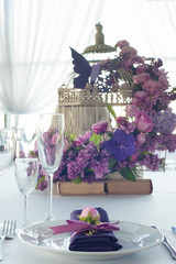Festive table setting in the restaurant with flowers. Wedding decor.