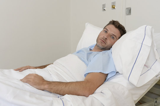 Young Patient Man Lying At Hospital Bed Resting Tired Looking Sad And Depressed Worried