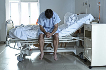 desperate man sitting at hospital bed alone sad and devastated s