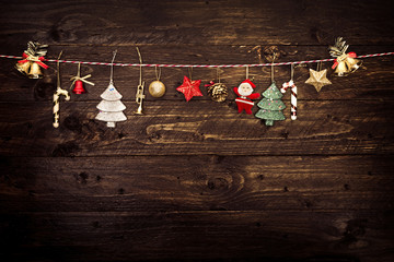 Christmas decoration and hanging on a rope with old wooden background. vintage color tone