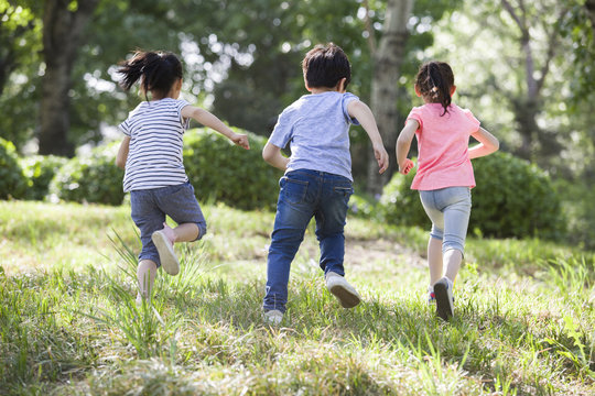 Happy children running in woods