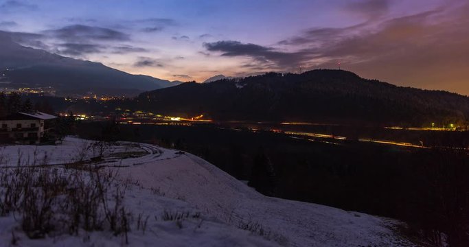 Innsbruck, Austria - view near city of Innsbruck in a valley with Brenner Autobahn and snowy Alps at sunset - Timelapse without motion