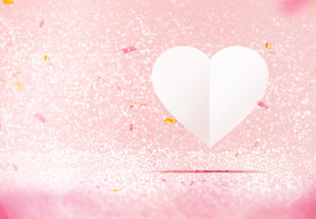 Paper white heart floating at pastel pink sparkling glitter room