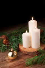 Christmas composition burning candles pine branches on wooden top