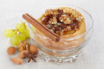 Apple baked with honey, nuts and raisins