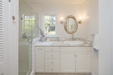 Beautiful bathroom with white marble and glass shower.