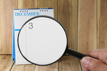 Magnifying glass in hand on calendar you can look third day of m