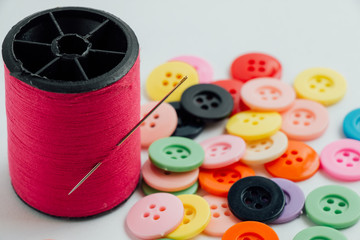 Selected focus on needle with thread. defocus buttons, sew instr