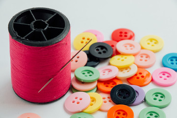 needle with thread/ Spool of thread and buttons, sew instrument