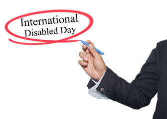 Hand of businessman write text in International Disabled Day iso