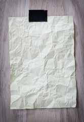 Yellow notepad paper crumpled of empty and copy space on wooden