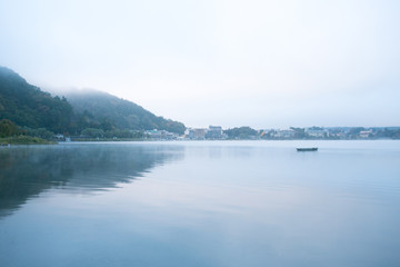  Lonely boat in the lake. Morning Kawaguchiko in Japan