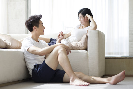 Happy young couple relaxing at home