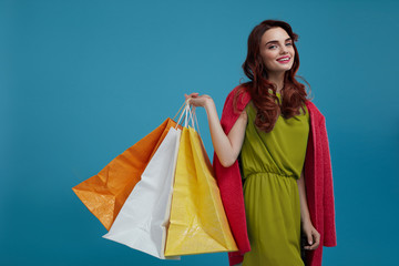 Fototapeta na wymiar Woman Shopping. Smiling Beautiful Fashion Model With Paper Bags
