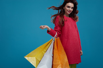 Woman Shopping. Smiling Beautiful Fashion Model With Paper Bags