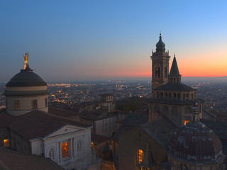 Bergamo - Old city (Citta Alta). One of the beautiful city in Italy. Lombardia. Evening sunset. Landscape on the old city, Cathedral, clock towers and the Po Valley.        
