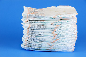 stacking diapers isolated on blue background