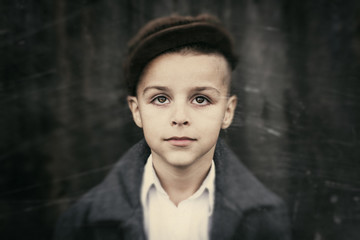 child, portrait of the boy with glasses with a background old scratched paper