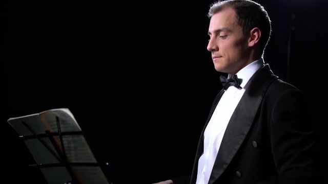 View on conductor during performance of orchestra
