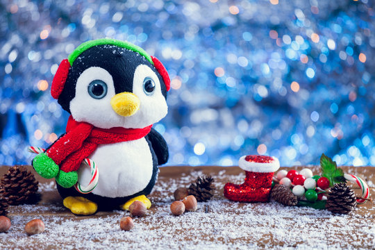 Cute Happy Penguin Christmas Toy Smiling On Snowy Wood