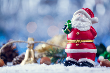 Mini Santa Claus Toy Statue With Jingle Bells On Snowy Wood