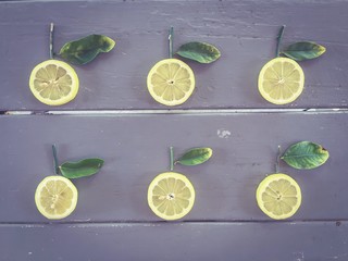 fresh lemons with green leaves on the wooden table