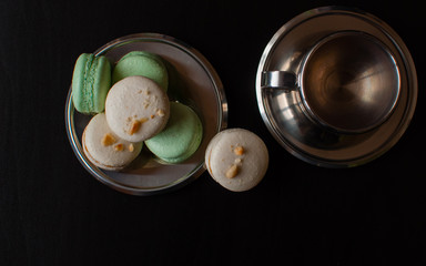 cup of coffe with french macaron on darck background.