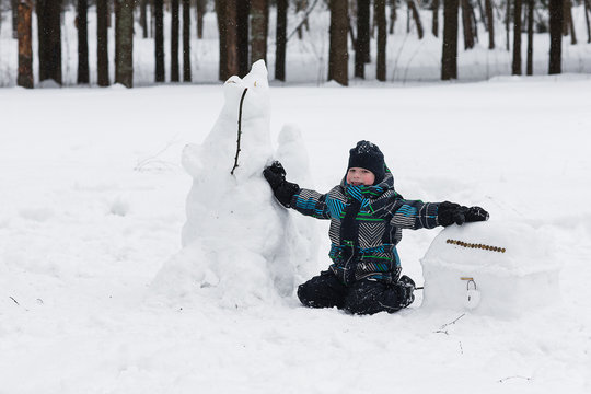 child enjoys the winter and playing with snow
