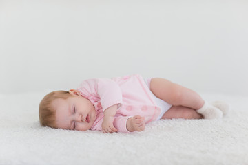 baby girl in a pink sleeping