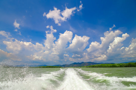 wave from speed boat travel at the sea with blue sky background
