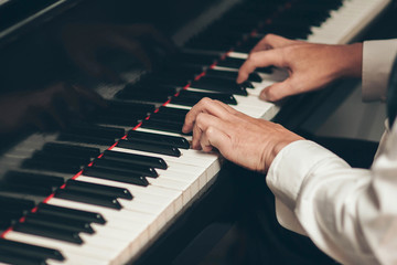 Close-up on a man's hand playing the piano