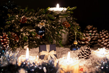 Christmas still life is with snow. New year's gift lies under the tree. 