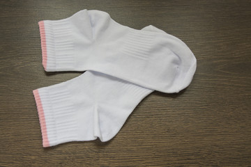beautiful cotton socks on a dark the wooden background 