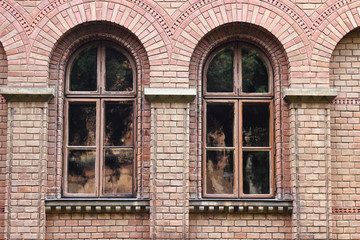 Fototapeta na wymiar Windows in a red brick wall
