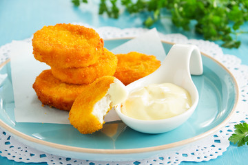 Homemade chicken nuggets with sauce.