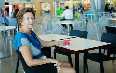 Portrait of beautiful 70 years old woman sitting in the airport