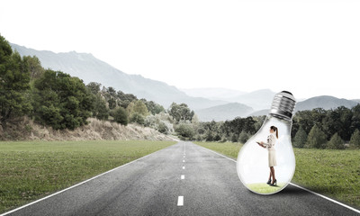 Businesswoman inside light bulb