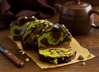 Chocolate pistachio cake with frosting.