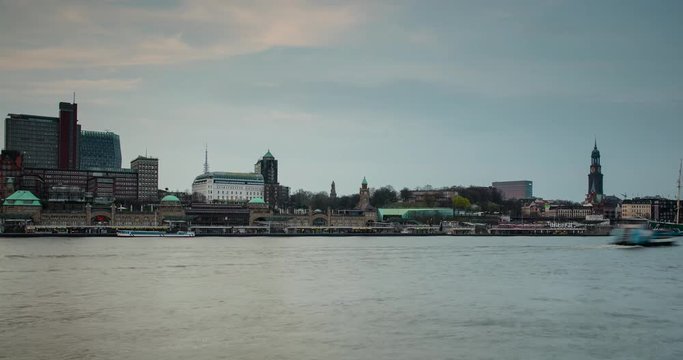 Hamburg, Germany - view over river Elbe with ships from south shore to Landungsbruecken, church Michel and ship Rickmer Rickmers at colorful sunset - Timelapse with zoom out
