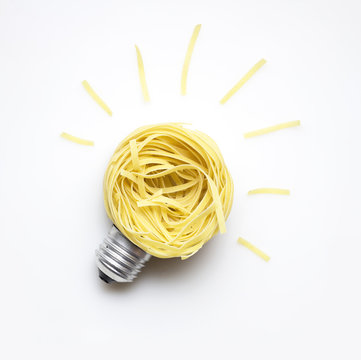 Food idea / Creative concept photo of  a bulb made of pasta on white background.