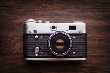 Vintage photo camera on a wooden table