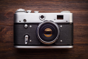 Vintage photo camera on a wooden table