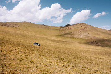Auto drives down in the mountains of Central Asia