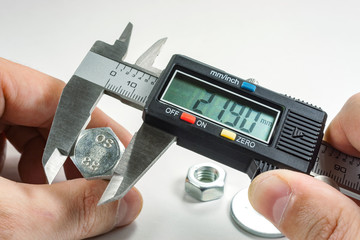 Measurements by a digital caliper in the master's hand