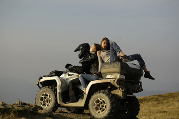 Fototapeta premium Man and girls ride quad