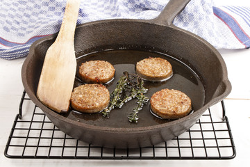 fried irish home made white pudding with oil in a pan
