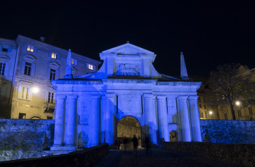 Obraz premium Bergamo - Old city (Citta Alta). One of the beautiful city in Italy. Lombardia. Landscape on the old gate named Porta San Giacomo during night lighted in blue color