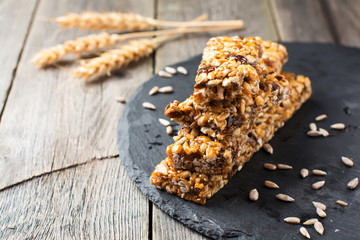 Roasted nuts and sunflower seeds in caramel and sugar on the old wooden background. Selective focus.