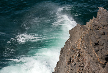 Waves breaking on rocky coast.