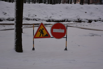 road signs in winter: Passage forbidden and repair, replacement of the pipeline